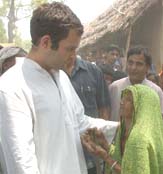 Congress MP from Amethi Rahul Gandhi listens to the woes of an old woman during his Jansampark campaign, in Rae Bareli on Sunday.