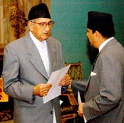 Nepals King Gyanendra, asks Girija Prasad Koirala about his health before administering him oath as Prime Minister during a ceremony at Narayanhiti Royal Palace in Kathmandu