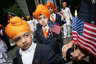 Children wave the US flag as they march down Broadway during the 19th Annual Sikh Day Parade in New York