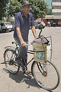 Hira Lal Yadav rides his seatless bicycle in Chandigarh on Monday. 
