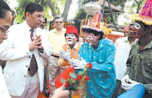 Chief Justice Y. K. Sabharwal meets with some labourers who are dressed as clowns to mark International Labour Day in the Capital on Monday. 