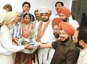 Mr Jasbir Singh, former minister, presents saplings to a newly wed couple at a marriage palace in Mandi Ahmedgarh
