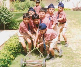 Students of Ryan International School mow the school lawn in Ludhiana