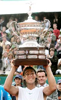Spains Rafael Nadal holds the trophy after beating compatriot Tommy Robredo in the final of the Open Seat Godo in Barcelona on Sunday