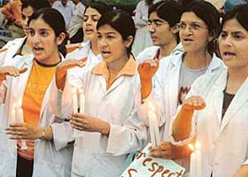 Doctors hold candles at a protest rally against the proposed increase in quota for OBCs in Chandigarh