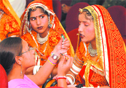 Teachers give finishing touches to the makeup of students taking part in an inter-school cultural competition of Kendriya Vidyalayas in Jalandhar