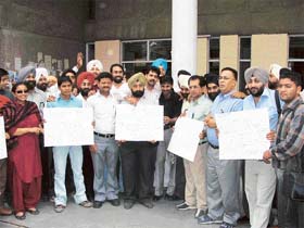 Mediapersons hold placards urging the government to respect the National Flag and the freedom of the Press in Ludhiana