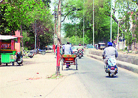 Electricity poles installed in the middle of the Maqbool Road pose a danger to commuters