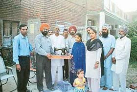 Mr Bahadur Singh gives away sewing machines to handicapped girls at Palsora