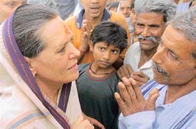 Congress President Sonia Gandhi talks with supporters as she arrives to address a rally in Rae Bareli on Wednesday. 