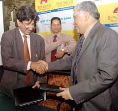 S.V. Prasad, CEO, Birla Mutual Fund, and Mr V. Sridar, CMD, UCO Bank, exchange the documents after signing an MoU in Kolkata
