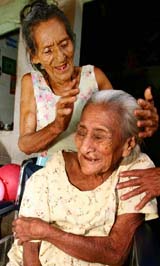 Salvadoran Cruz Hernandez Rivas (seated) celebrates her 128th birthday with her 80-year-old daughter Patrona Hernandez