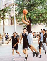 A cager of DAV Senior Secondary School tries to pocket the ball during the Junior State Basketball Championship at New Public School, Sector 18, Chandigarh, on Friday
