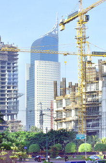 Construction cranes and concrete pillars rise into the sky as Indonesias capital Jakarta continues to build the office buildings, malls and hotels in the city centre.