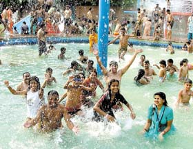 Visitors splash around to beat the heat at Appu Ghar in the Capital