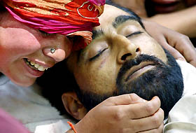 A Kashmiri woman relative cries beside the body of Mushtaq Bhat, a rebel commander, during his funeral in Tral, 45 km south of Srinagar, on Sunday