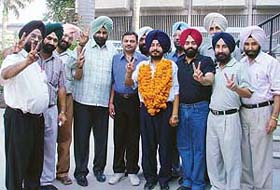 Supporters of Dr Manjit Singh Komal (garlanded) celebrate his victory as president of the Ludhiana district of the Punjab and Chandigarh College Teachers' Union