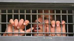 An Israeli settler is arrested during an eviction of a house in the West Bank City of Hebron on Sunday.