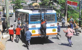 Coolies chasing the buses well before they reach the terminal is a common sight in Shimla