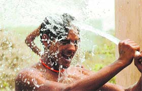 A youth cools himself with water