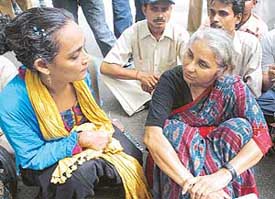Narmada Bachao Andolan (NBA) leader Medha Patkar and Booker Prize winner Arundhati Roy with NBA activists at a demonstration in front of the Supreme Court in New Delhi on Tuesday.
