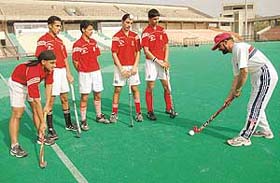 The Chandigarh Hockey Academy players who have been selected to attend coaching camp for the forthcoming Asia Cup get tips from coach Jasbir Bajwa at the Sector 42 hockey stadium in Chandigarh