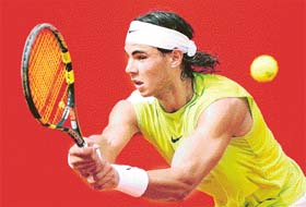 Spains Rafael Nadal returns the ball to compatriot Carlos Moya during the first round of the Rome Masters in Rome