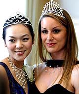 Winner of the Miss Tourism International 2005, Isabelle Lamant of France, poses with Miss China Fu Jing at a press conference in Beijing on Wednesday to announce the 2006 pageant in China