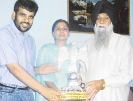 Former Punjab Finance Minister Kanwaljit Singh and President of the nagar panchayat N.K. Sharma felicitate Gurneet Tej in Zirakpur on Thursday.