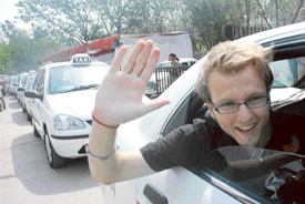 A tourist waves after the flagging-off ceremony of an AC taxi service at Rock Garden, Chandigarh, on Thursday.