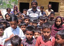 Mohammad Yusuf (in the centre) is the lone teacher for over 150 children at makeshift primary school in Bela base camp