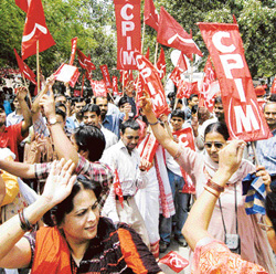 Activists of the Left parties celebrate victory in the state elections in  West Bengal and Kerala outside the party office in New Delhi on Thursday. 