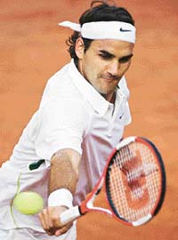Roger Federer of Switzerland in action against Potito Starace of Italy during the second round of the Rome Masters in Rome