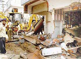 Structures that were pulled down in a demolition drive in Ram Darbar on Friday.