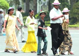 A family on its way to Parliament to witness the proceedings, intense heat notwithstanding, in the Capital on Friday