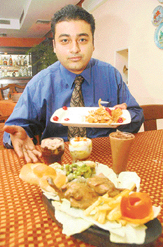 Restaurant Manager Vikram Bedi holds up the newly introduced sizzlers at Moti Mahal-17