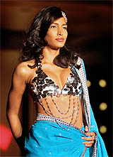 A model displays a designer saree at the launch of Rang