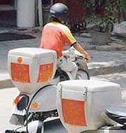 Modified scooters being used by fast food joints for commercial activity.