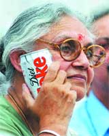 Chief Minister Sheila Dikshit tries to cool off with a soft drink cane during the inauguration of the largest rainwater harvesting project in the Capital on Saturday