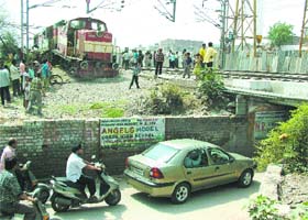 A view of the derailed rail engine near Ikehri Puli under bridge in Jalandhar