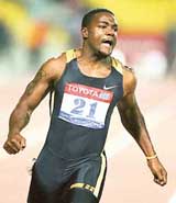 Justin Gatlin of the USA crosses the finish line to set a new 100m world record at the Qatar Super Grand Prix in Doha on Friday
