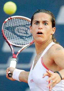 Frances Amelie Mauresmo returns a shot to Martina Hingis of Switzerland during their quarterfinal at the WTA German Open tennis tournament in Berlin on Friday