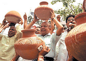 BJP activists led by Delhi party president Dr Harsh Vardhan demonstrate with earthen pots as they shout anti-Delhi government slogans during a protest against the shortage of drinking water and electricity supply in the Capital on Sunday.