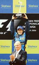 Spanish Renault driver Fernando Alonso holds his trophy on the podium behind King Juan Carlos of Spain after winning the Formula 1 Spanish Grand Prix on Sunday in Montmelo