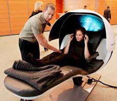 Ms Athena Dogias is helped by Brendan Torazzi into a sleep pod in a central business district office building in Sydney