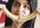 A model poses with an item of antique traditional jewellery during a press conference