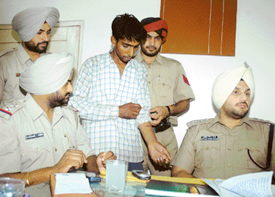 The police presents Jasbir Singh, who has been charged with the murder of his wife, before mediapersons in Ludhiana on Tuesday.