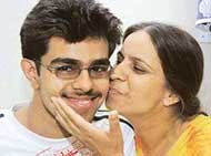 Sahil, the city topper, being hugged by his jubilant mother on Wednesday. 