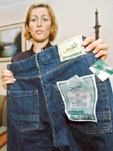 In this picture taken on May 6, 2006, Ms Susanna Cavalli, chief of product development for an Italian company, shows a blue denim jeans at her office in Karachi.