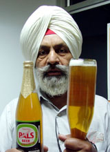 Mr Shamsher Singh, a retired Army jawan, shows bottles of beer containing some foreign particles in Ludhiana